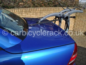 side view of a blue mercedes slk with a bike rack fitted 