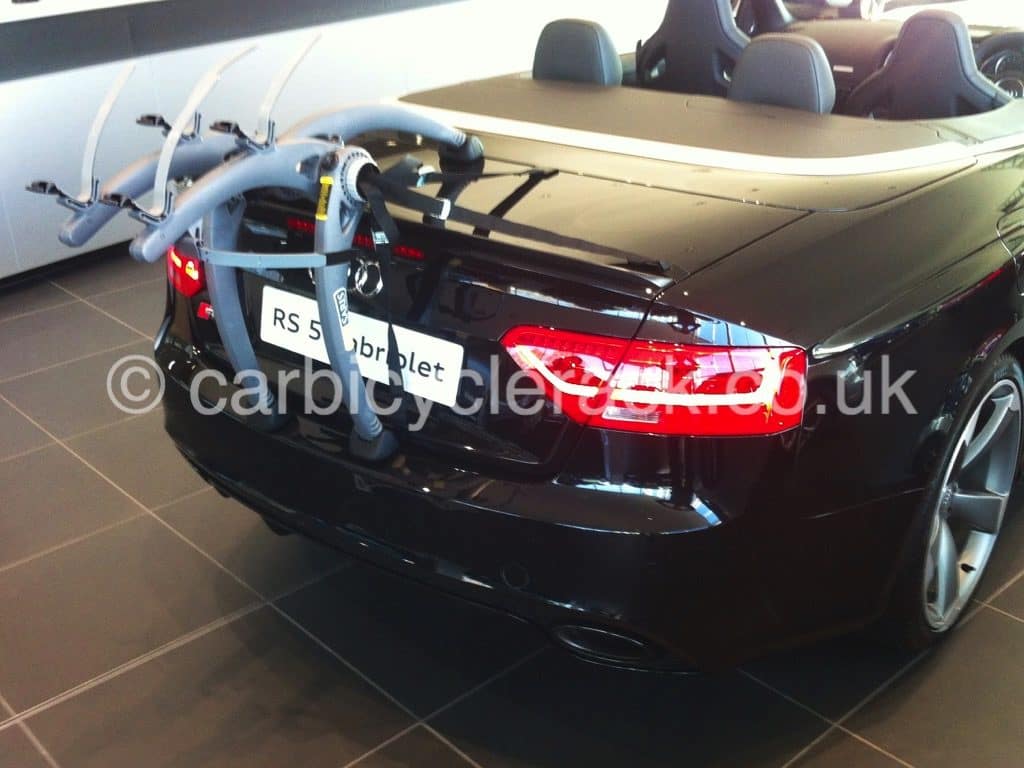 black audi a5 cabriolet in an audi showroom with a bike rack fitted